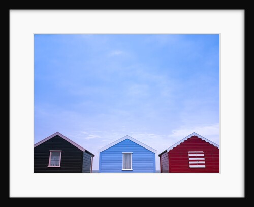 Beach huts in a row against sky by Assaf Frank